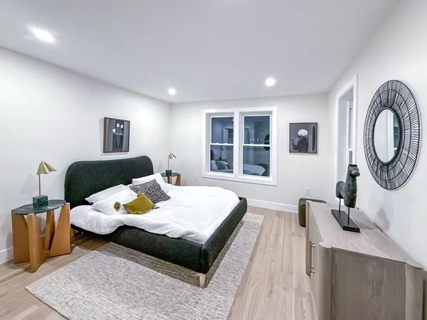 a bedroom with furniture and a window