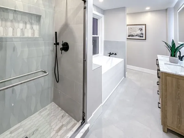 a bathroom with a bathtub and a shower