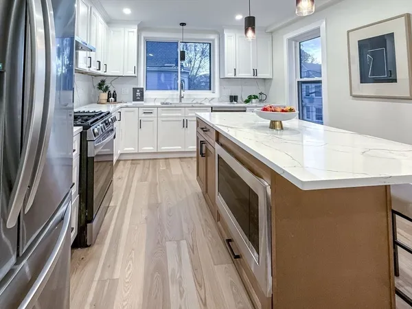 a kitchen with a sink stove and cabinets