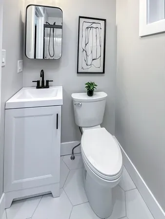 a bathroom with a toilet sink and mirror