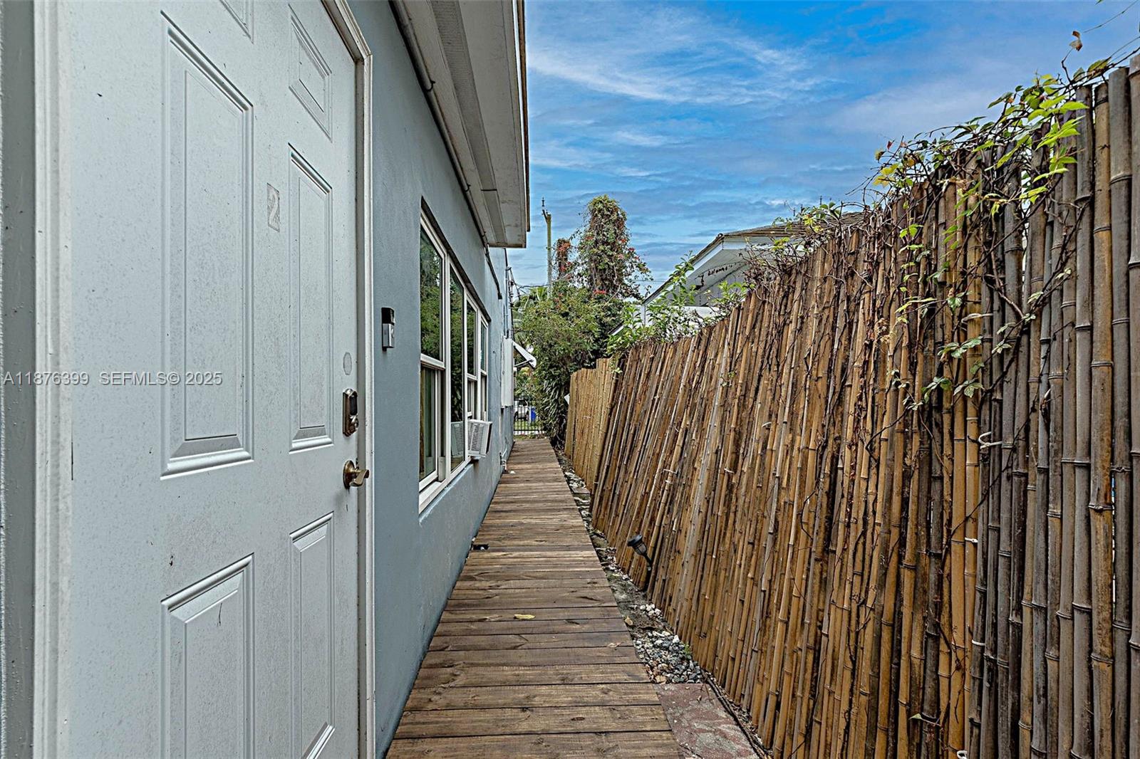 259 Northeast 56th Street, Unit 2 Miami, FL 33137 - Photo 2 of 23 a view of a pathway of a building with wooden stairs