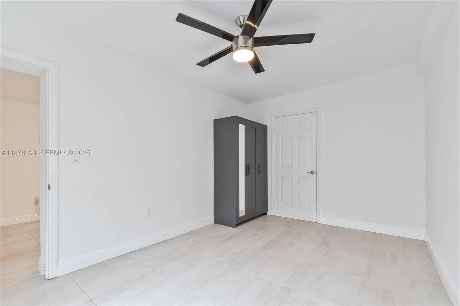 259 Northeast 56th Street, Unit 2 Miami, FL 33137 - Photo 9 of 23 an empty room with closet and ceiling fan
