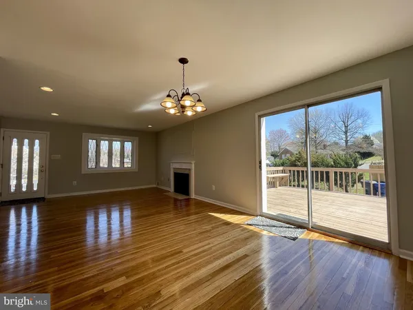 a view of a livingroom with wooden floor and chandelier