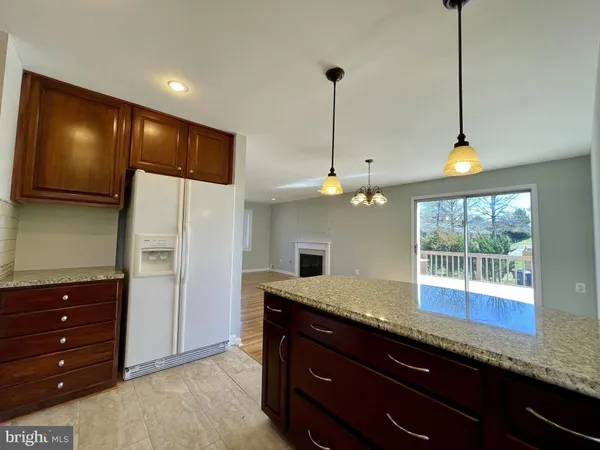 a kitchen with a sink and dishwasher with wooden floor