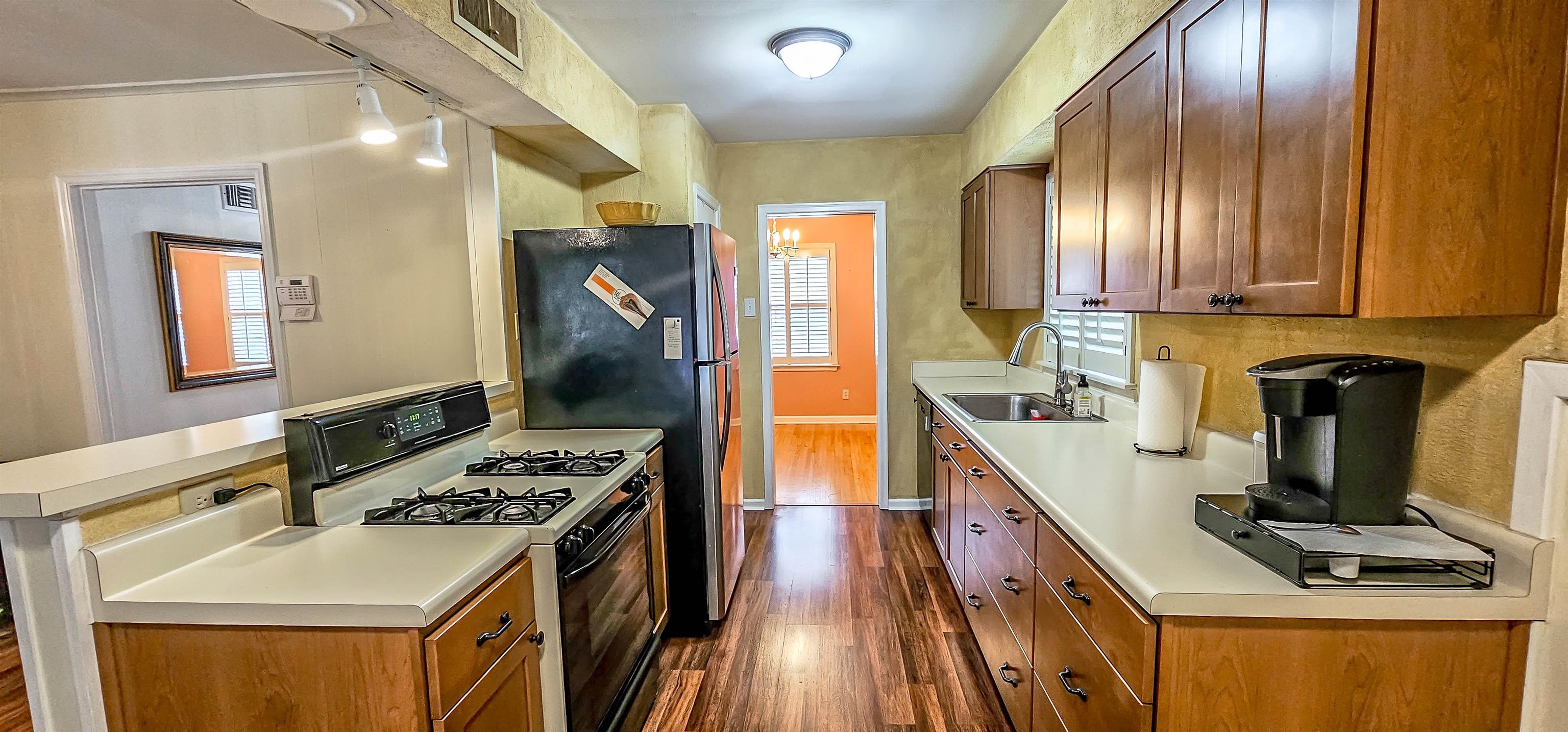 5246 Quince Road Memphis, TN 38117 - Photo 11 of 28 a kitchen with stainless steel appliances granite countertop a stove a sink and a refrigerator