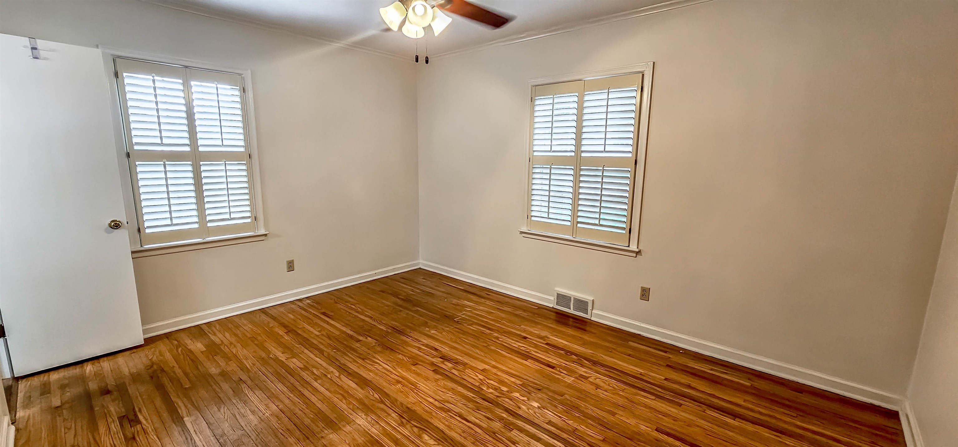 5246 Quince Road Memphis, TN 38117 - Photo 15 of 28 a view of an empty room with wooden floor and a window