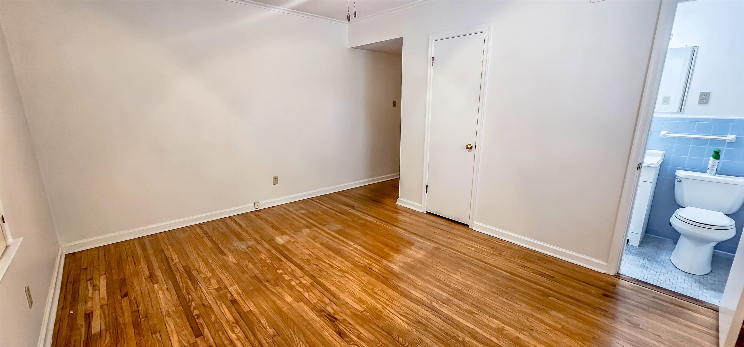 5246 Quince Road Memphis, TN 38117 - Photo 16 of 28 a view of a room with wooden floor and bathroom