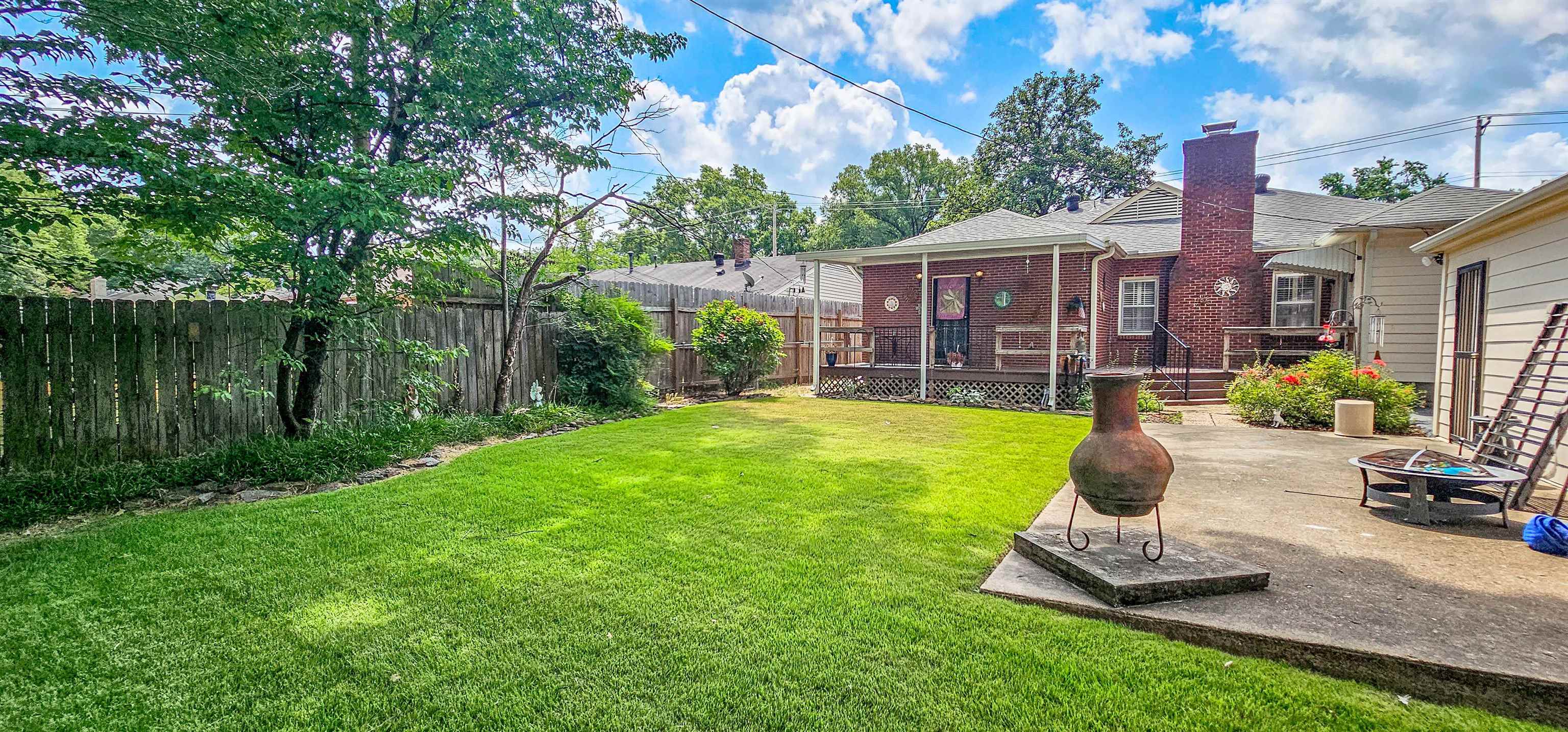 5246 Quince Road Memphis, TN 38117 - Photo 27 of 28 a front view of a house with garden and a patio