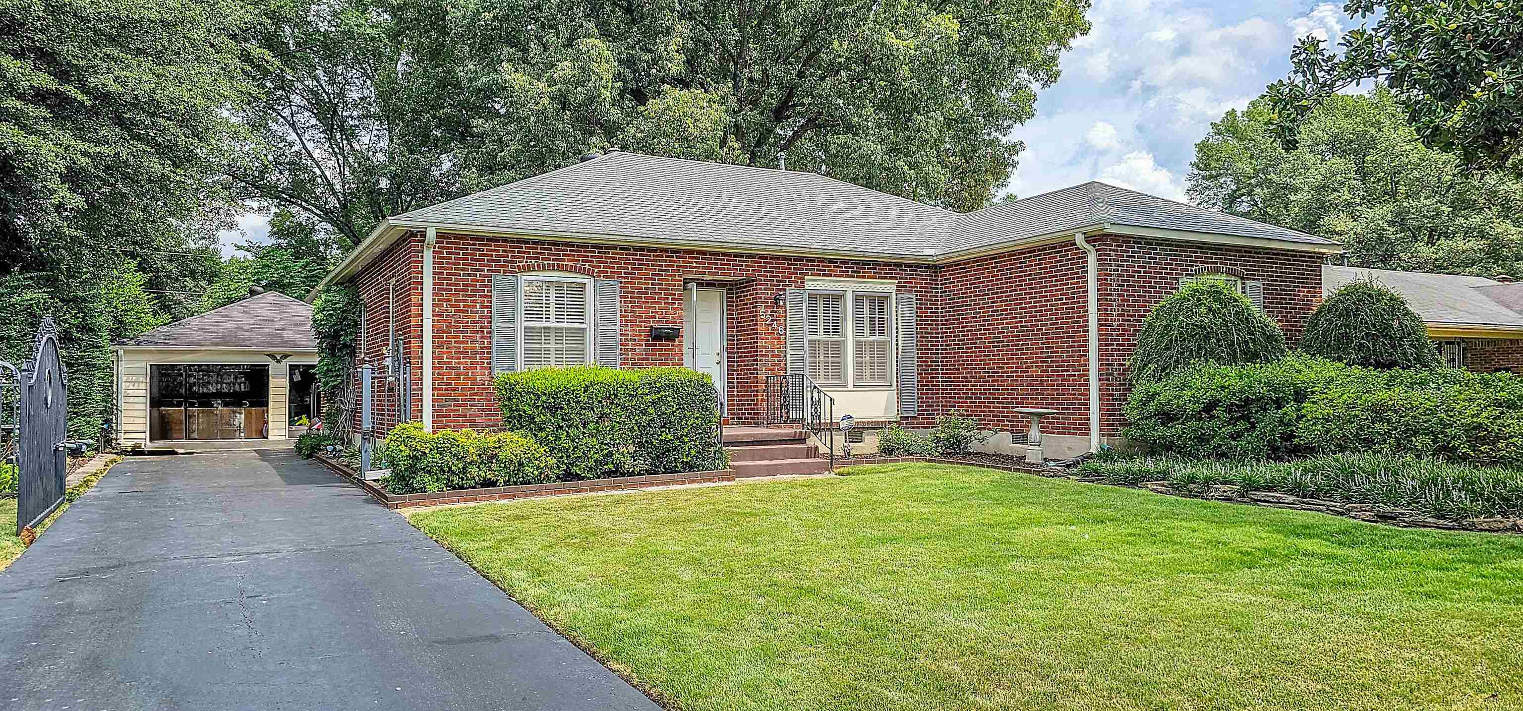 5246 Quince Road Memphis, TN 38117 - Photo 3 of 28 a front view of a house with a yard and porch