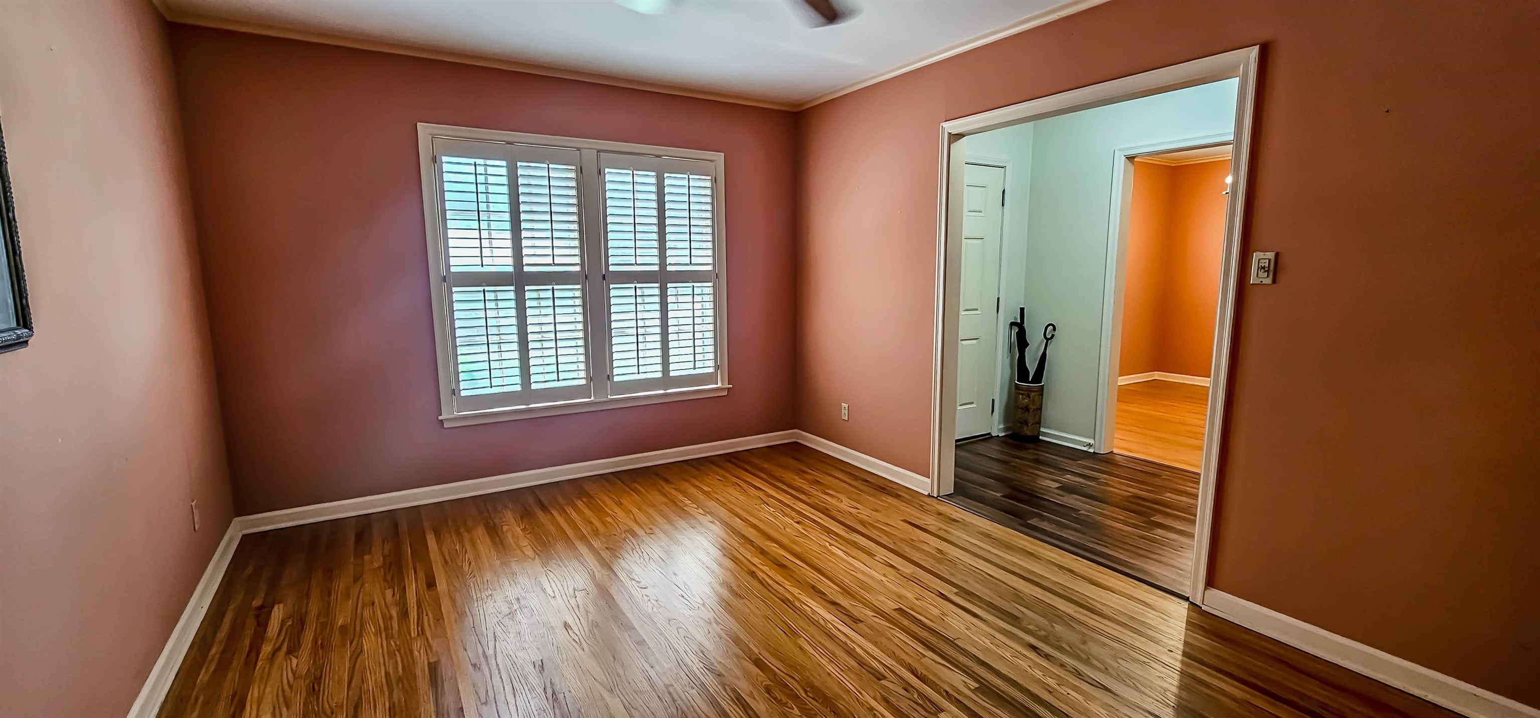 5246 Quince Road Memphis, TN 38117 - Photo 5 of 28 an empty room with wooden floor and a window