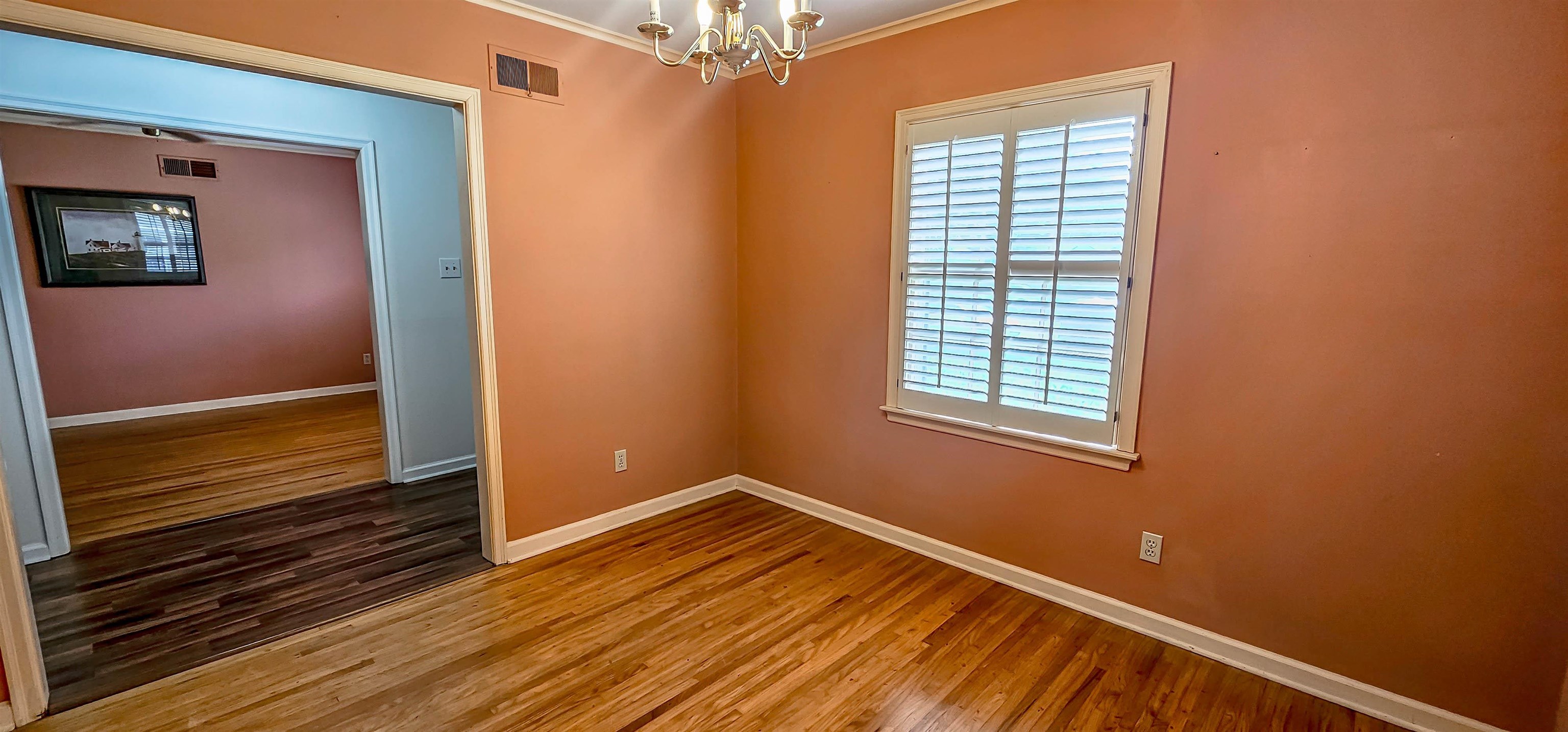 5246 Quince Road Memphis, TN 38117 - Photo 6 of 28 a view of an empty room with wooden floor and a window