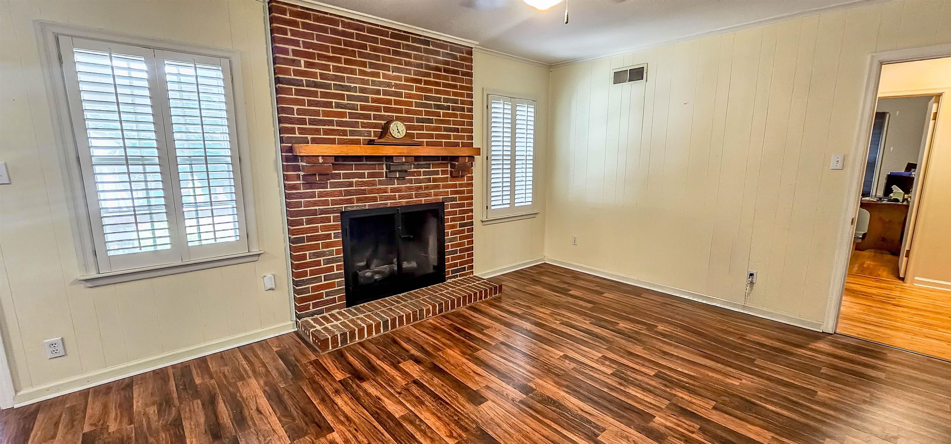 5246 Quince Road Memphis, TN 38117 - Photo 8 of 28 a view of empty room with wooden floor and fireplace