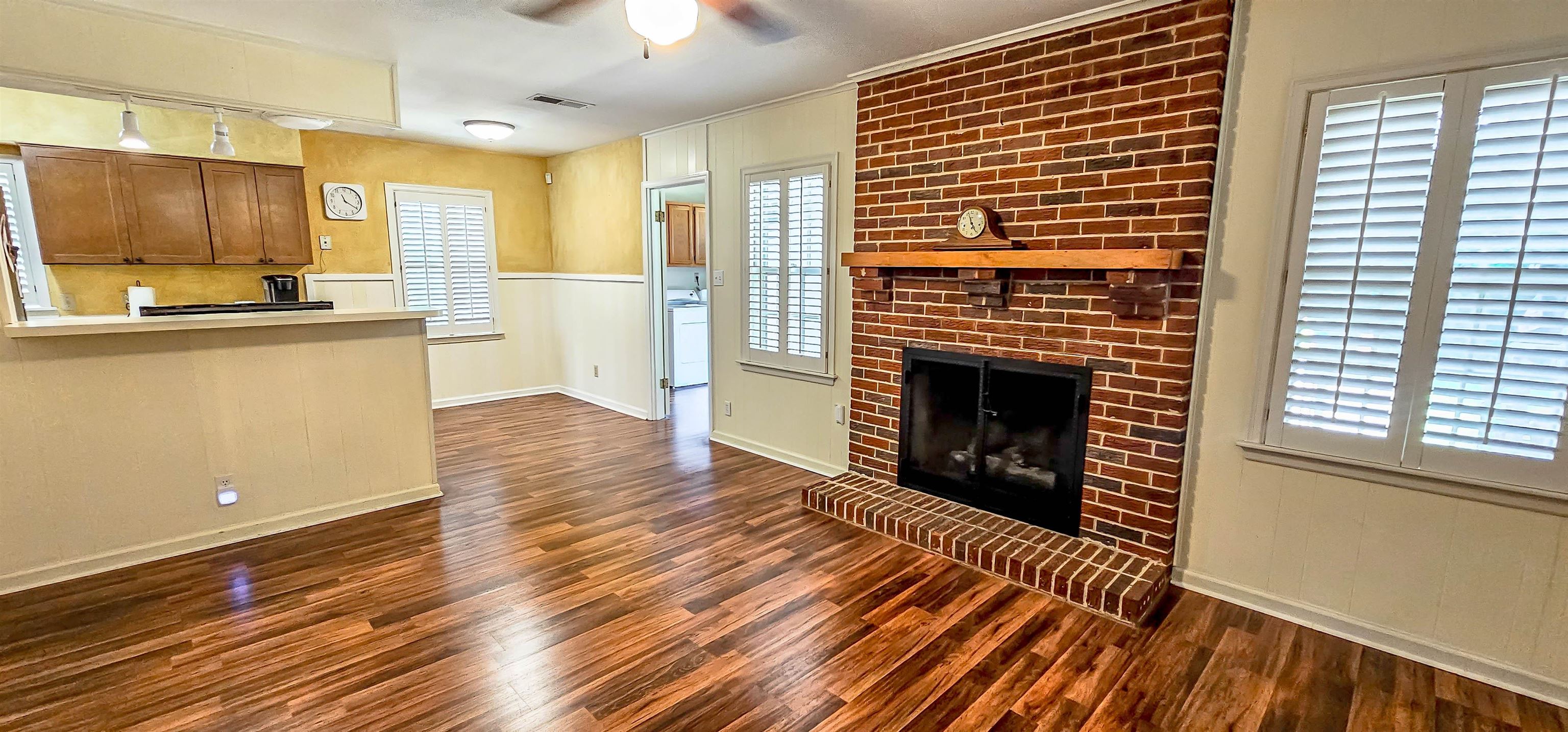 5246 Quince Road Memphis, TN 38117 - Photo 9 of 28 a view of a kitchen with wooden floor and a fireplace