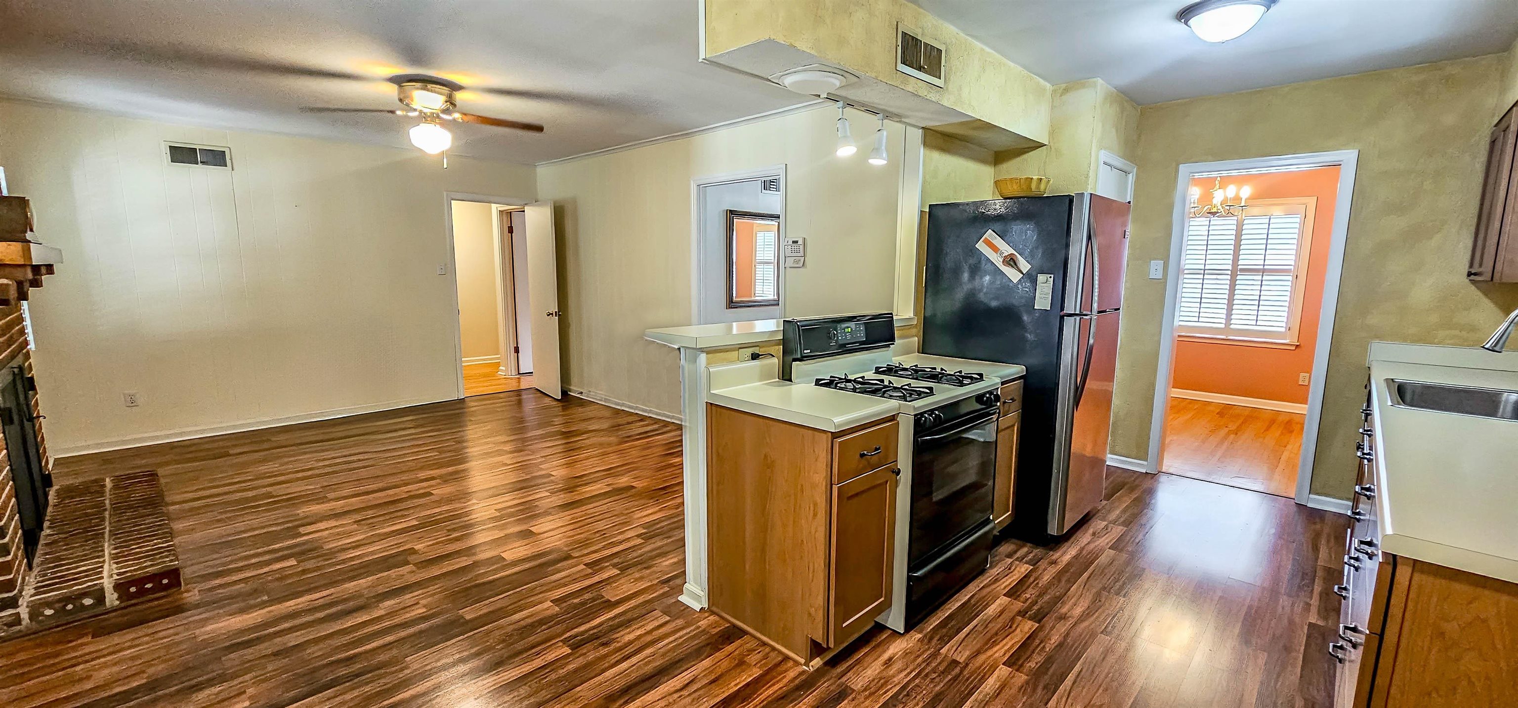 5246 Quince Road Memphis, TN 38117 - Photo 10 of 28 a kitchen with stainless steel appliances granite countertop a stove and a refrigerator
