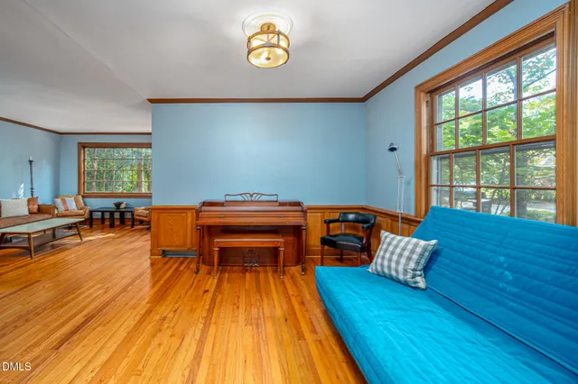 a dining room with furniture and a book shelf