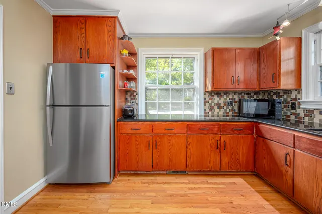 a view of staircase with wooden floor and a window