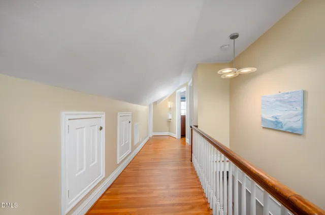 a view of a yard with plants and trees