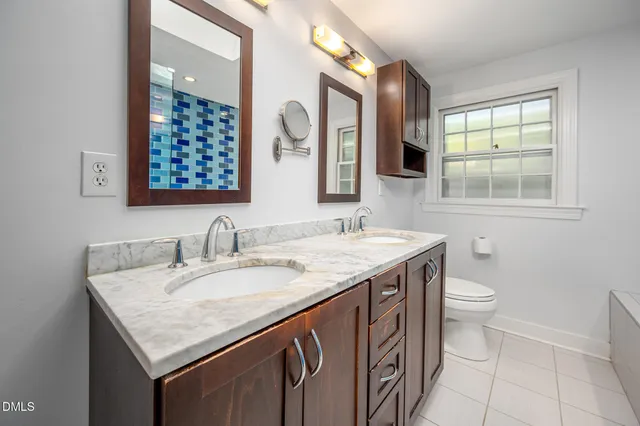 a view of a house with a yard and a fence