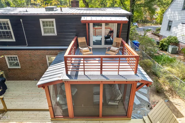 an aerial view of house with yard and mountain view in back