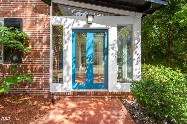 a living room with furniture and floor to ceiling windows