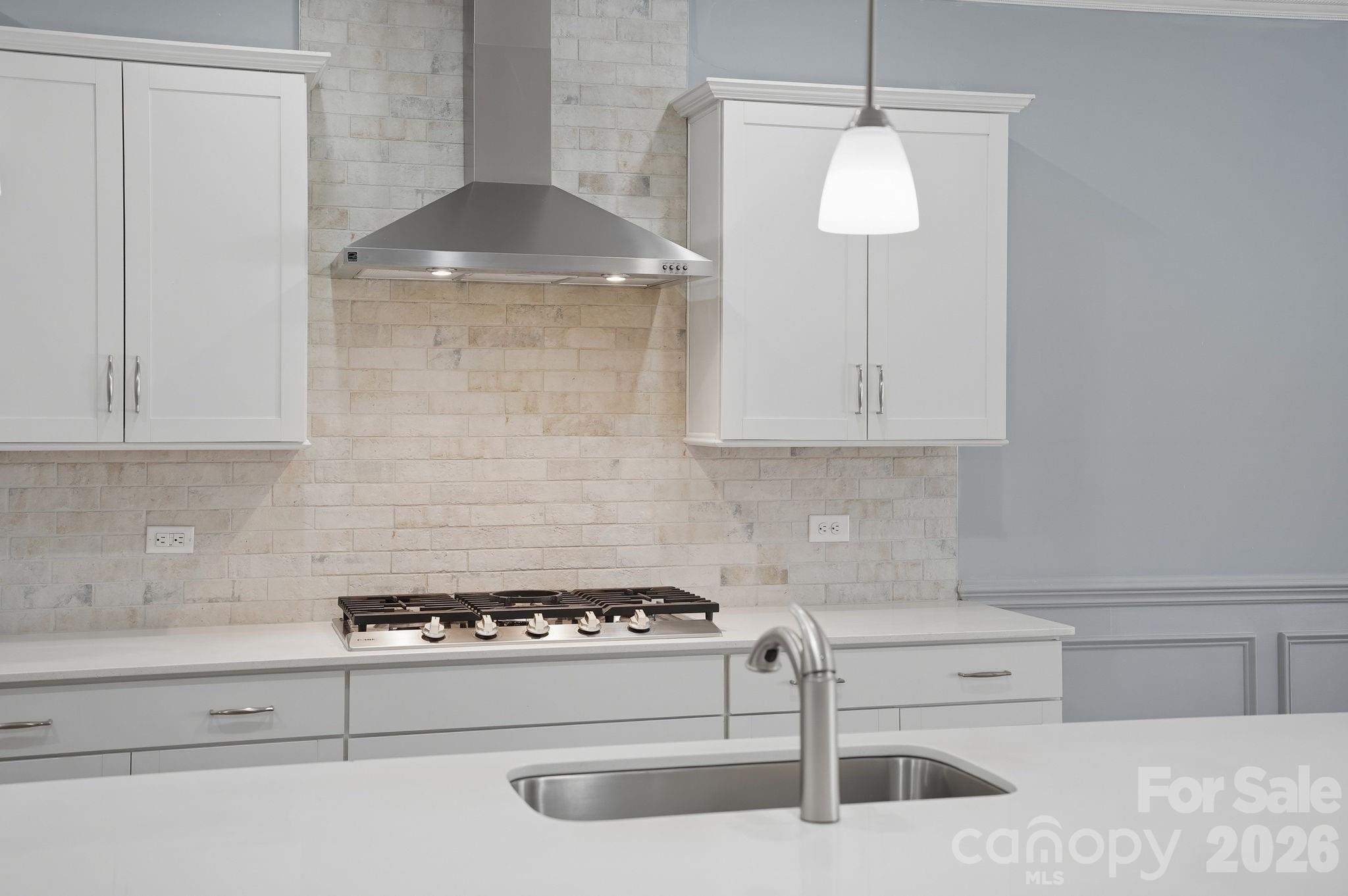 4029 Spring Garden Street Fort Mill, SC 29715 - Photo 18 of 48 a kitchen with a stove and white cabinets