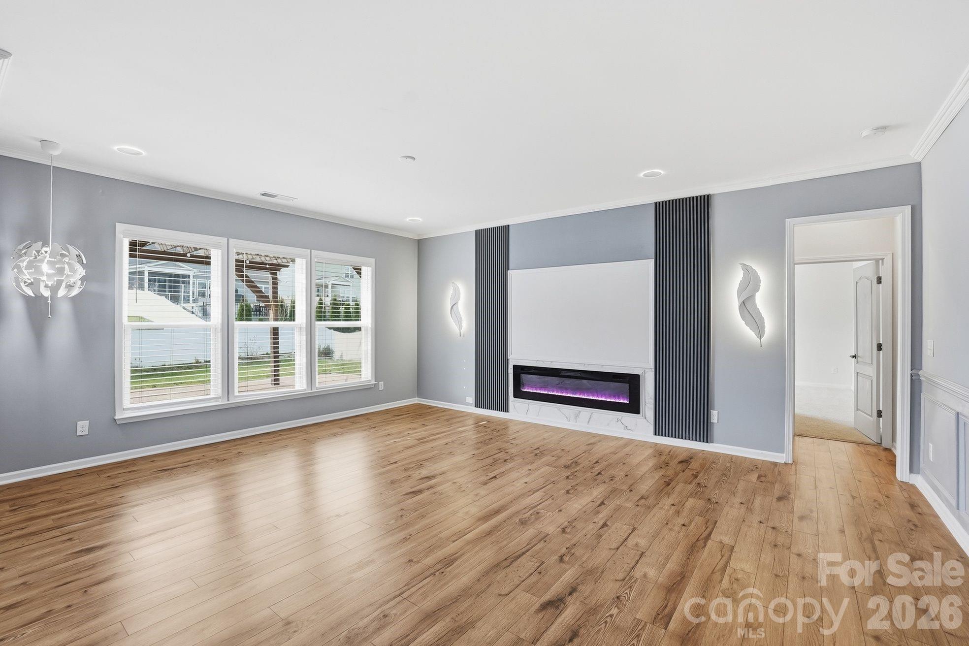 4029 Spring Garden Street Fort Mill, SC 29715 - Photo 19 of 48 a view of an empty room with a window and wooden floor