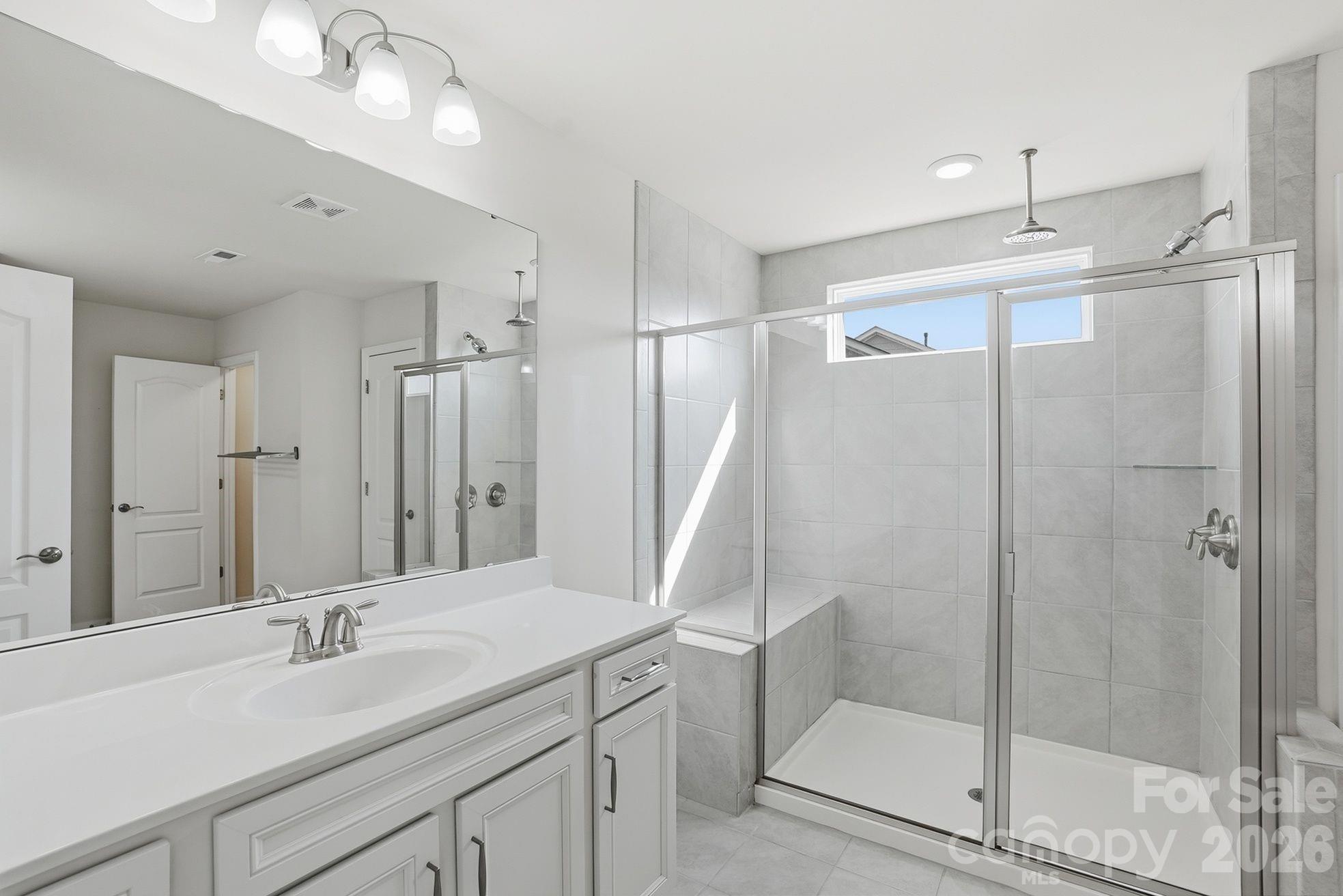 4029 Spring Garden Street Fort Mill, SC 29715 - Photo 24 of 48 a bathroom with a shower sink and mirror