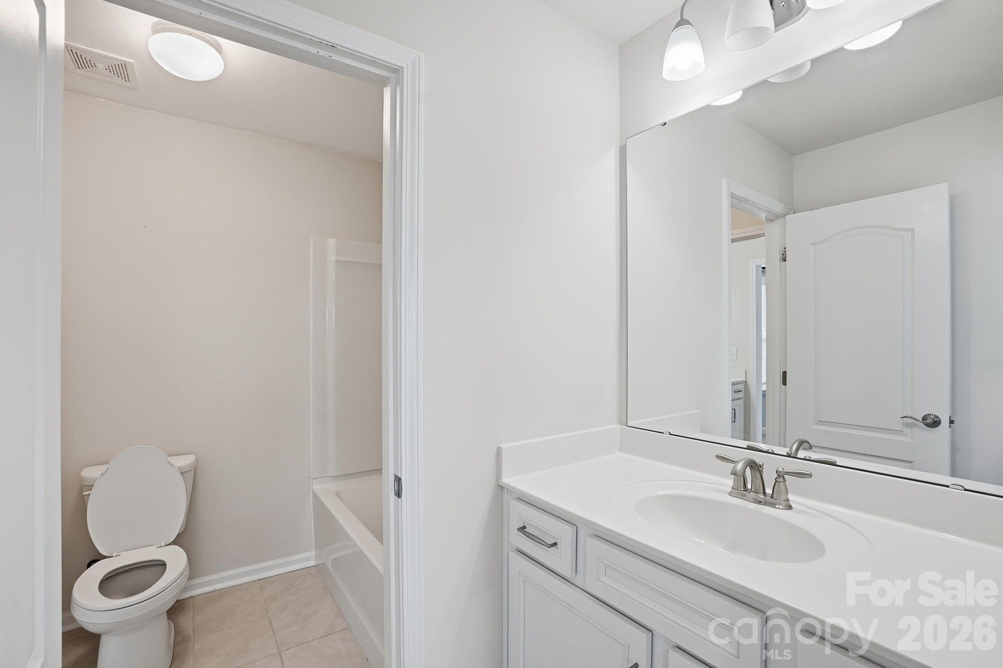 4029 Spring Garden Street Fort Mill, SC 29715 - Photo 32 of 48 a bathroom with a granite countertop sink toilet and shower