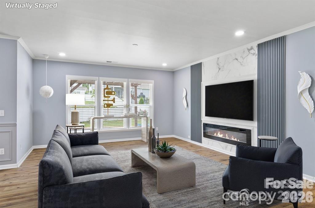 4029 Spring Garden Street Fort Mill, SC 29715 - Photo 7 of 48 a living room with furniture a flat screen tv and a large window