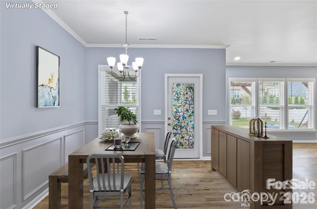 4029 Spring Garden Street Fort Mill, SC 29715 - Photo 9 of 48 a dining room with furniture a chandelier and window