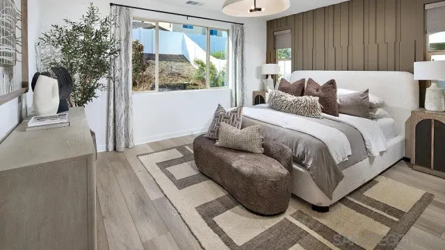 a bedroom with a bed and a large window