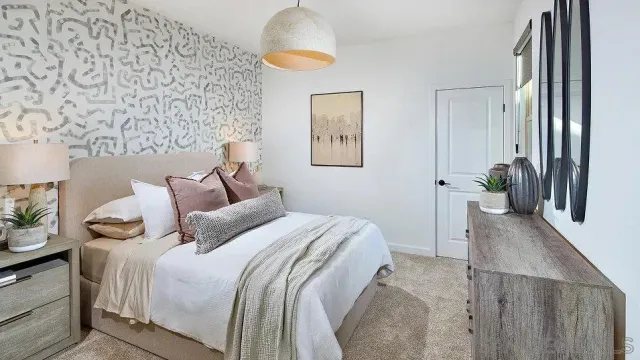 a bedroom with a bed and a chandelier