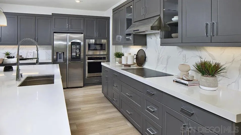 5556 Alethea Way Oceanside, CA 92057 - Photo 2 of 26 a kitchen with stainless steel appliances a sink a counter space and cabinets