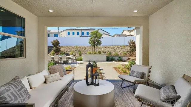a living room with furniture and a mirror