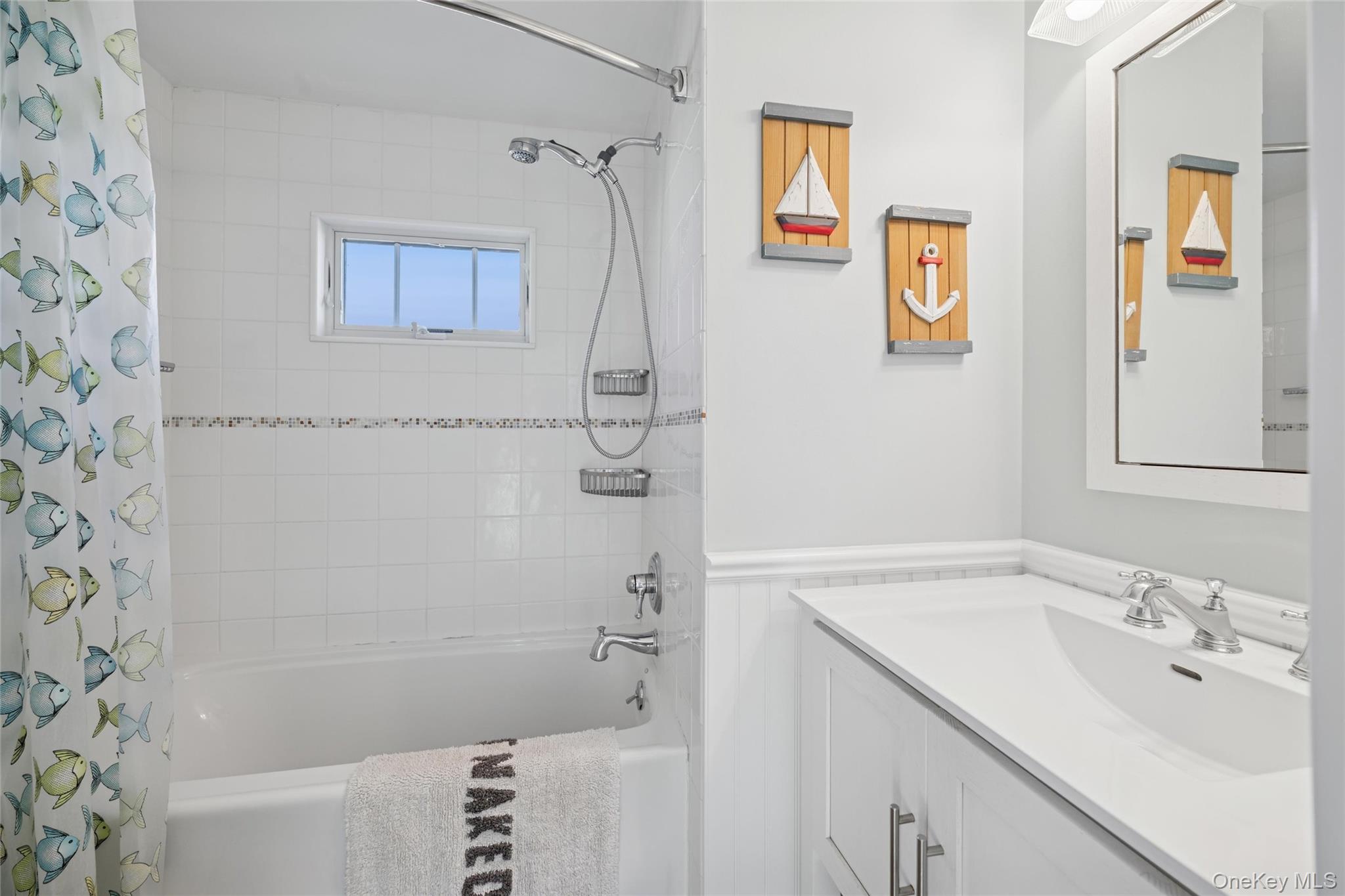 100 Deforest Road, Unit 25 Montauk, NY 11954 - Photo 11 of 21 a bathroom with a sink a mirror a bathtub and shower