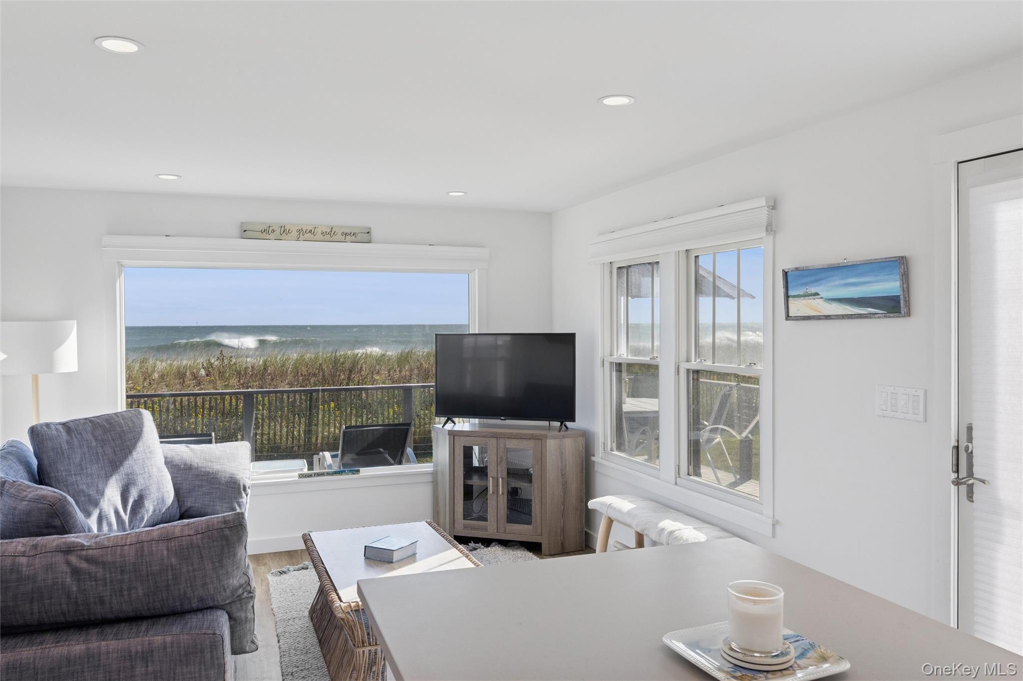 100 Deforest Road, Unit 25 Montauk, NY 11954 - Photo 3 of 21 a living room with furniture and a flat screen tv