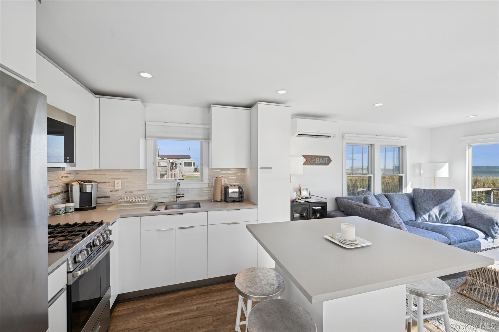 100 Deforest Road, Unit 25 Montauk, NY 11954 - Photo 4 of 21 a kitchen with a stove a sink a dining table and chairs