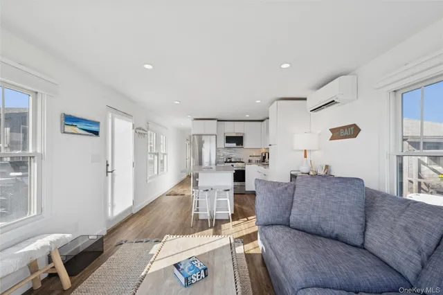 a living room with furniture and view of kitchen