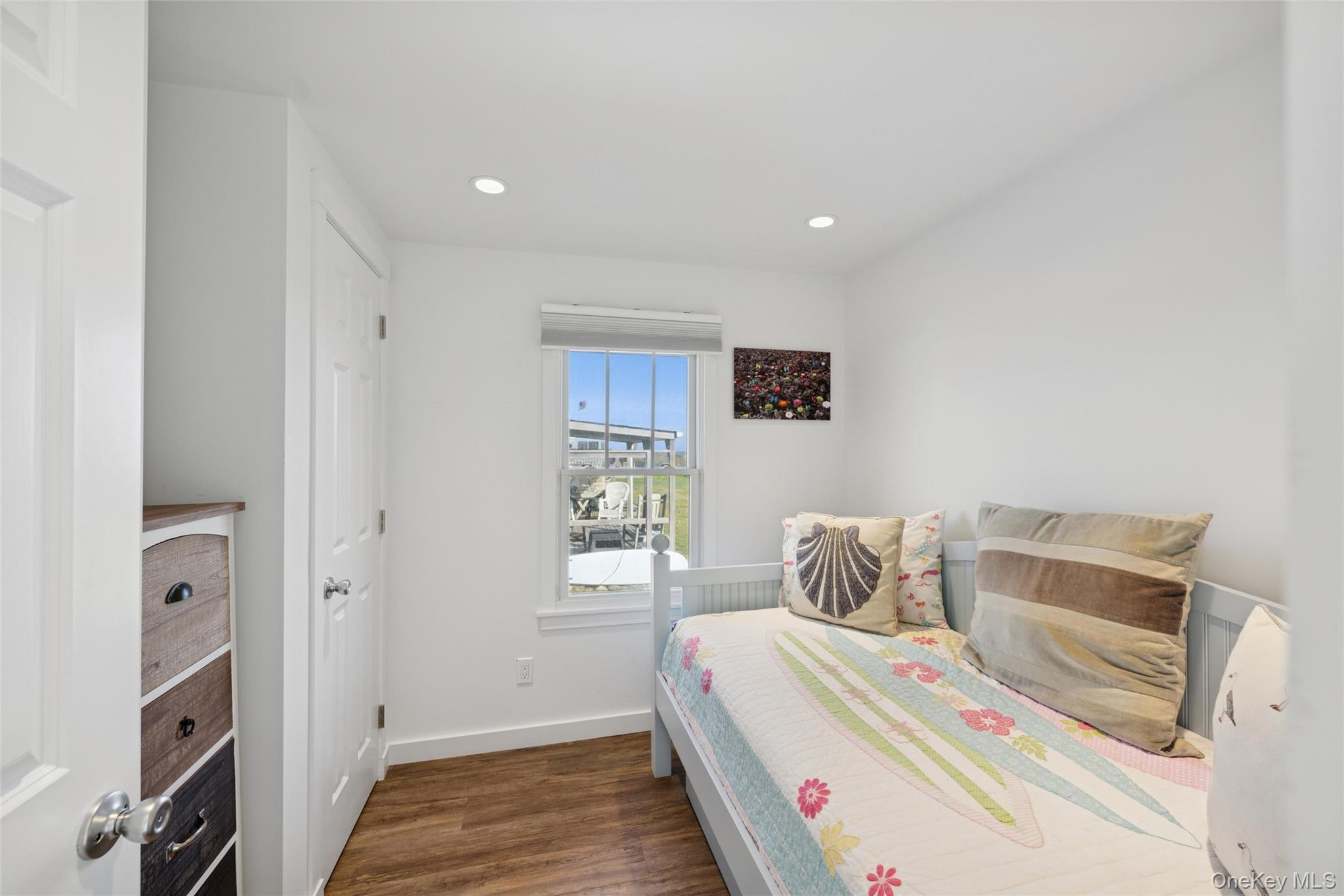 100 Deforest Road, Unit 25 Montauk, NY 11954 - Photo 9 of 21 a bedroom with a bed and wooden floor