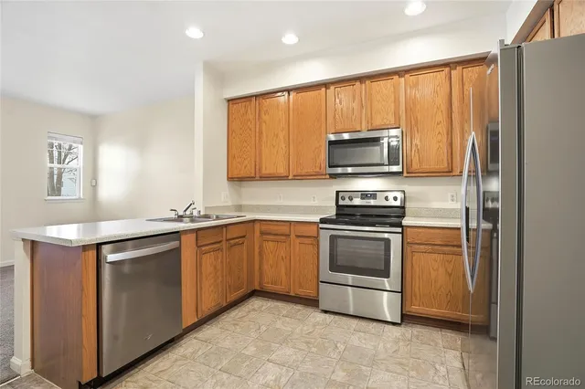 a kitchen with a stove microwave and sink