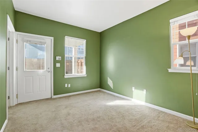 a view of an empty room with windows