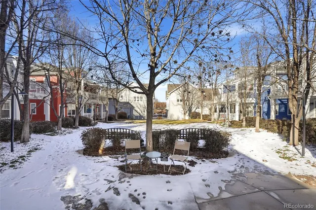 a front view of a building with snow on the road