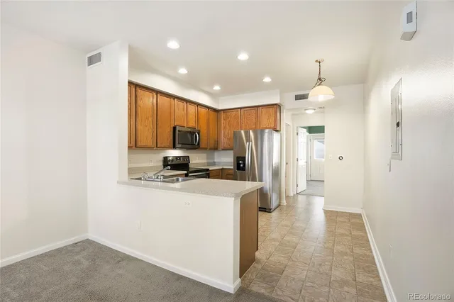 a kitchen with stainless steel appliances a refrigerator sink and stove