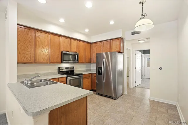 a kitchen with refrigerator cabinets and furniture