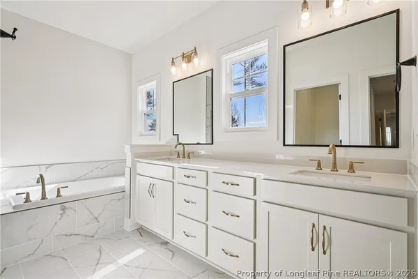 a bathroom with a bathtub and a shower