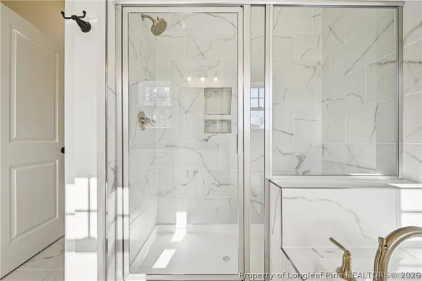 a view of a livingroom with a ceiling fan and wooden floor