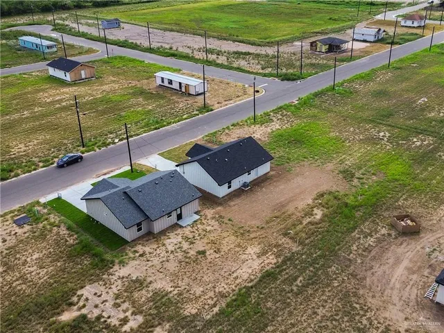 a view of a backyard with sitting area