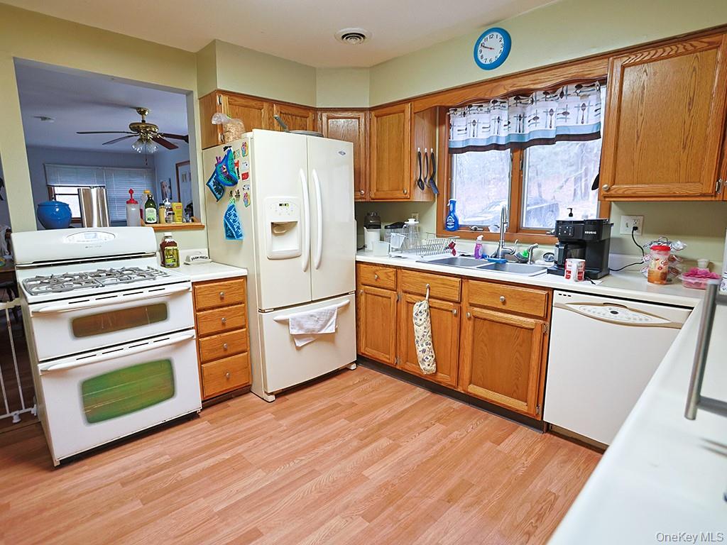 68 Kennel Road Cuddebackville, NY 12729 - Photo 14 of 21 a kitchen with a stove a refrigerator and a microwave
