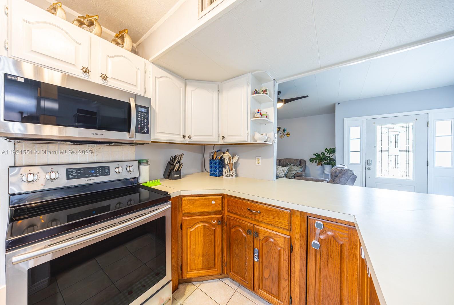780 95th Street Marathon, FL 33050 - Photo 13 of 31 a kitchen with stainless steel appliances a stove a microwave and cabinets
