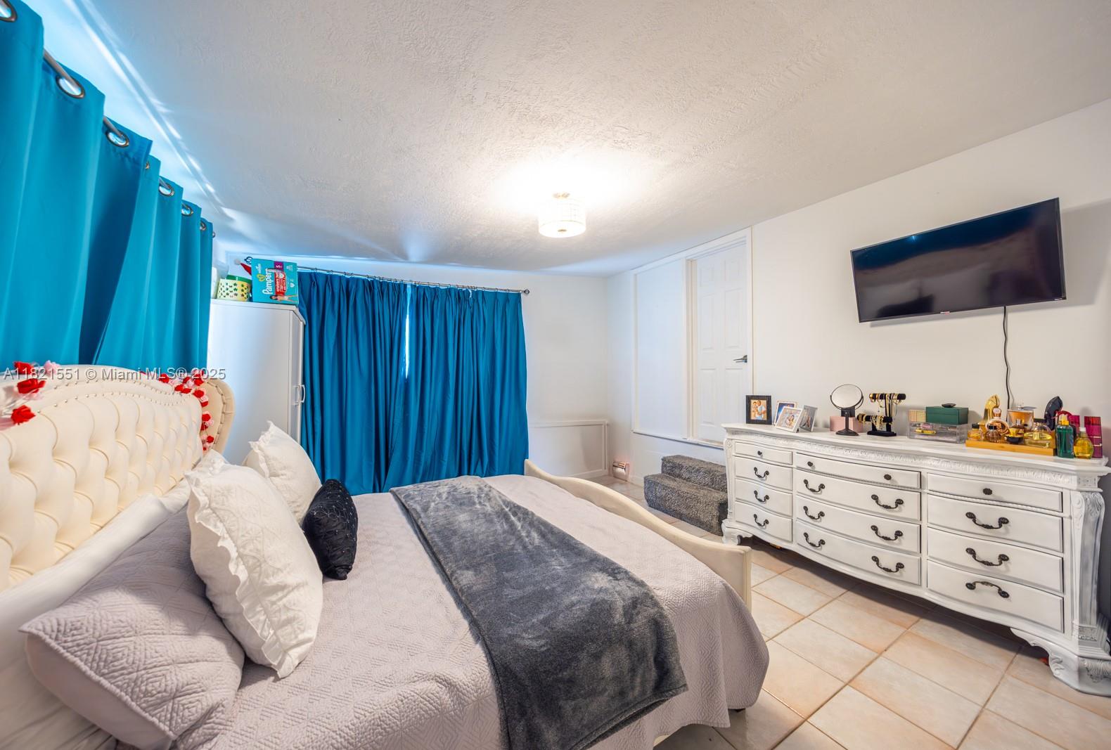 780 95th Street Marathon, FL 33050 - Photo 17 of 31 a bedroom with a large bed and a flat screen tv